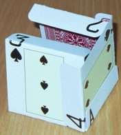 The fourth card is placed to the right of the first card, inside the flap of this first card but with its own flaps to the outside of the second and third cards